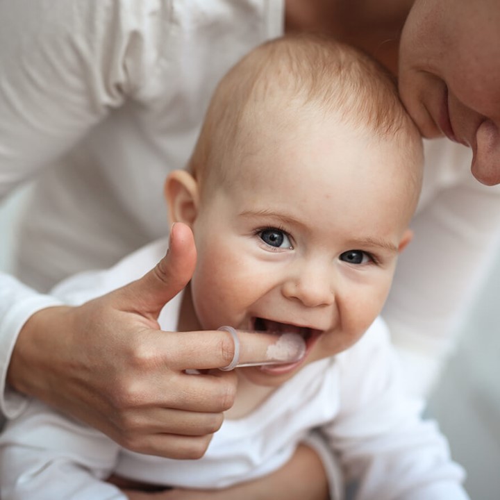 Baby and mother Support baby with teething with massage